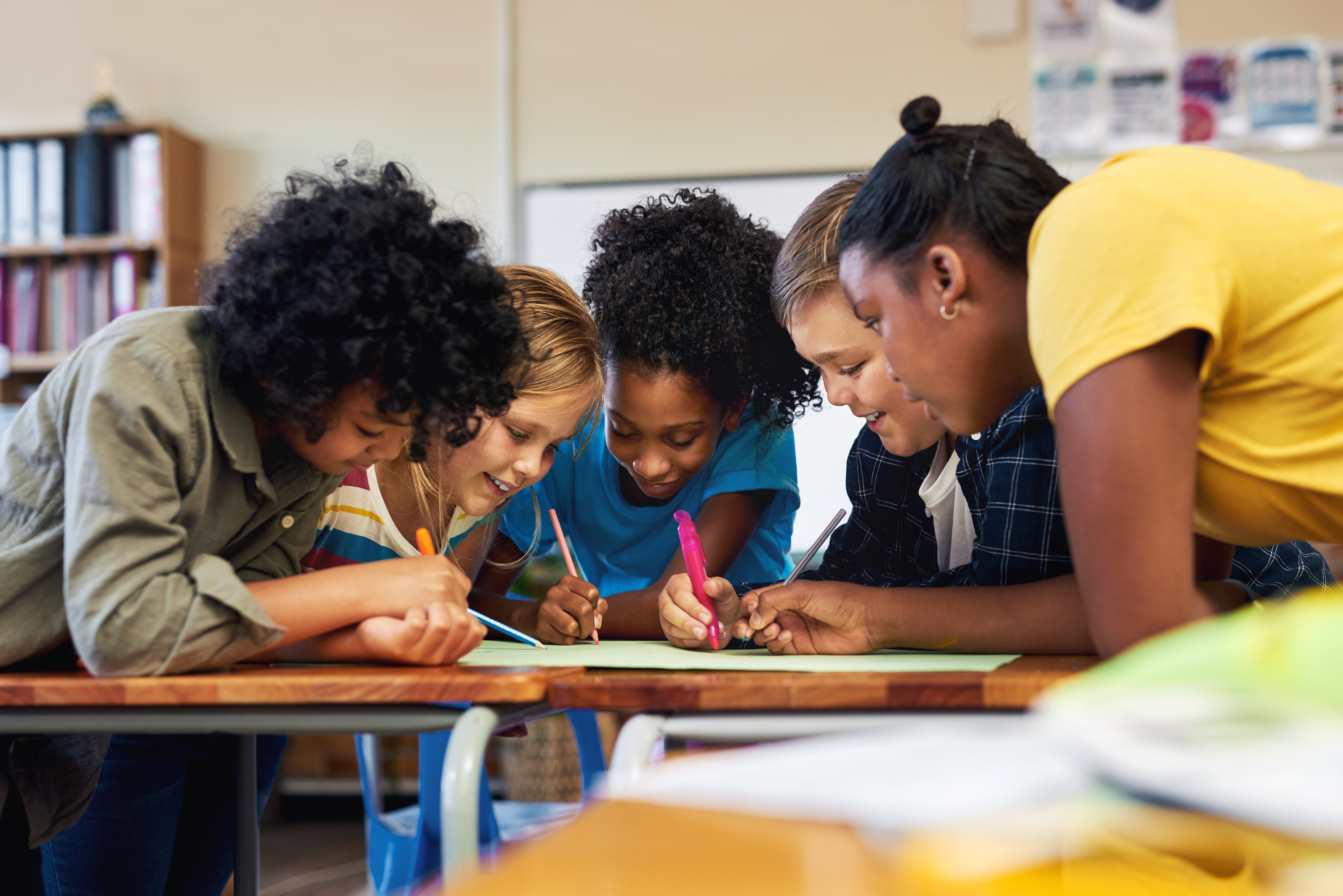 Young children complete an activity together during a learning program.