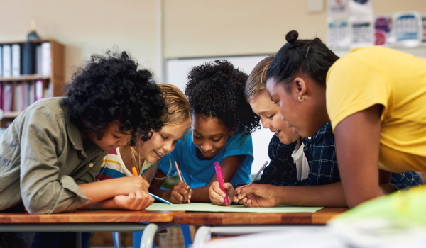 Young children partake in a brain break activity together during a learning program. 