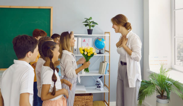 A youth program leader receives flowers from the children in her program. 