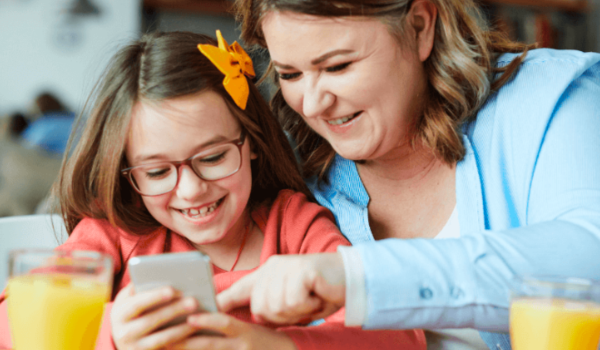 A mother and daughter complete an activity together at a family engagement event. 